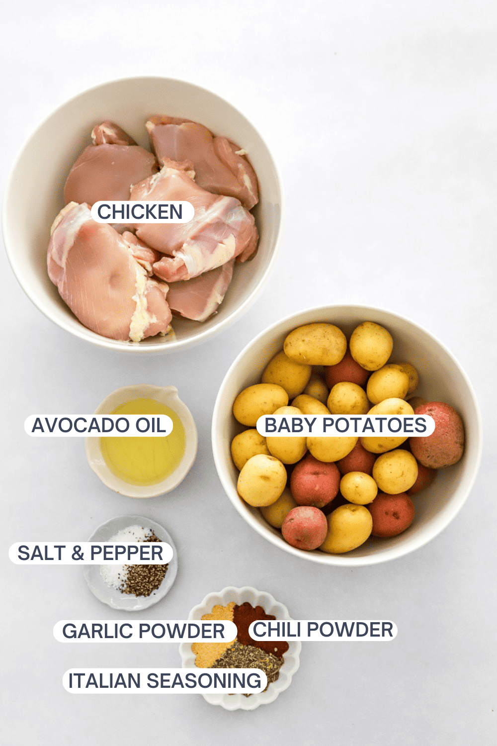 Ingredient for air fryer chicken and potatoes with labels over each ingredient.