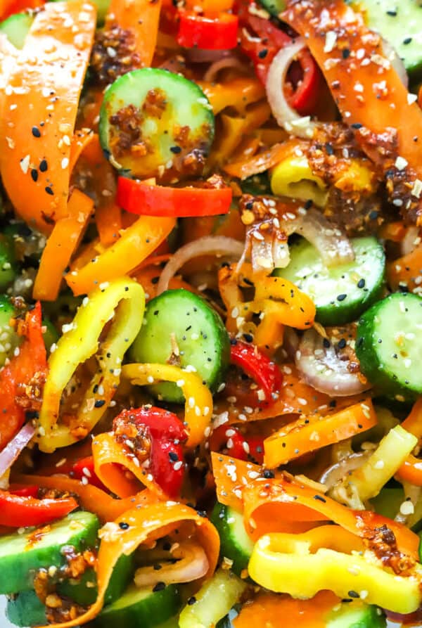 Close up of cucumber sweet pepper salad mixed in dressing.
