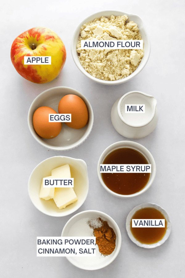 Ingredients for apple cinnamon Pancakes in bowls with labels over each ingredient.