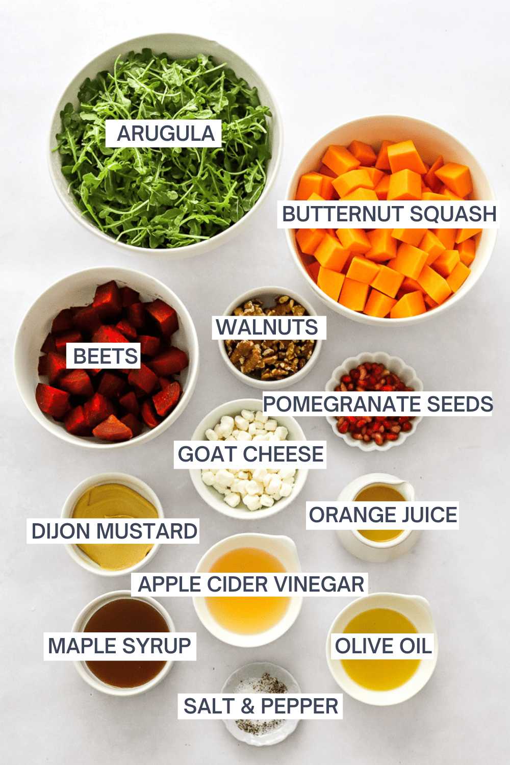 Ingredients for roasted beet and squash salad in bowls with labels over each ingredient.