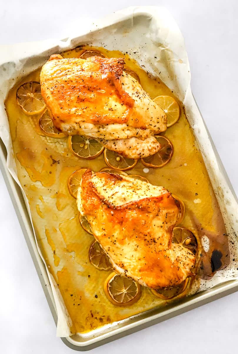 Cooked, roasted boneless turkey breasts on a baking sheet.