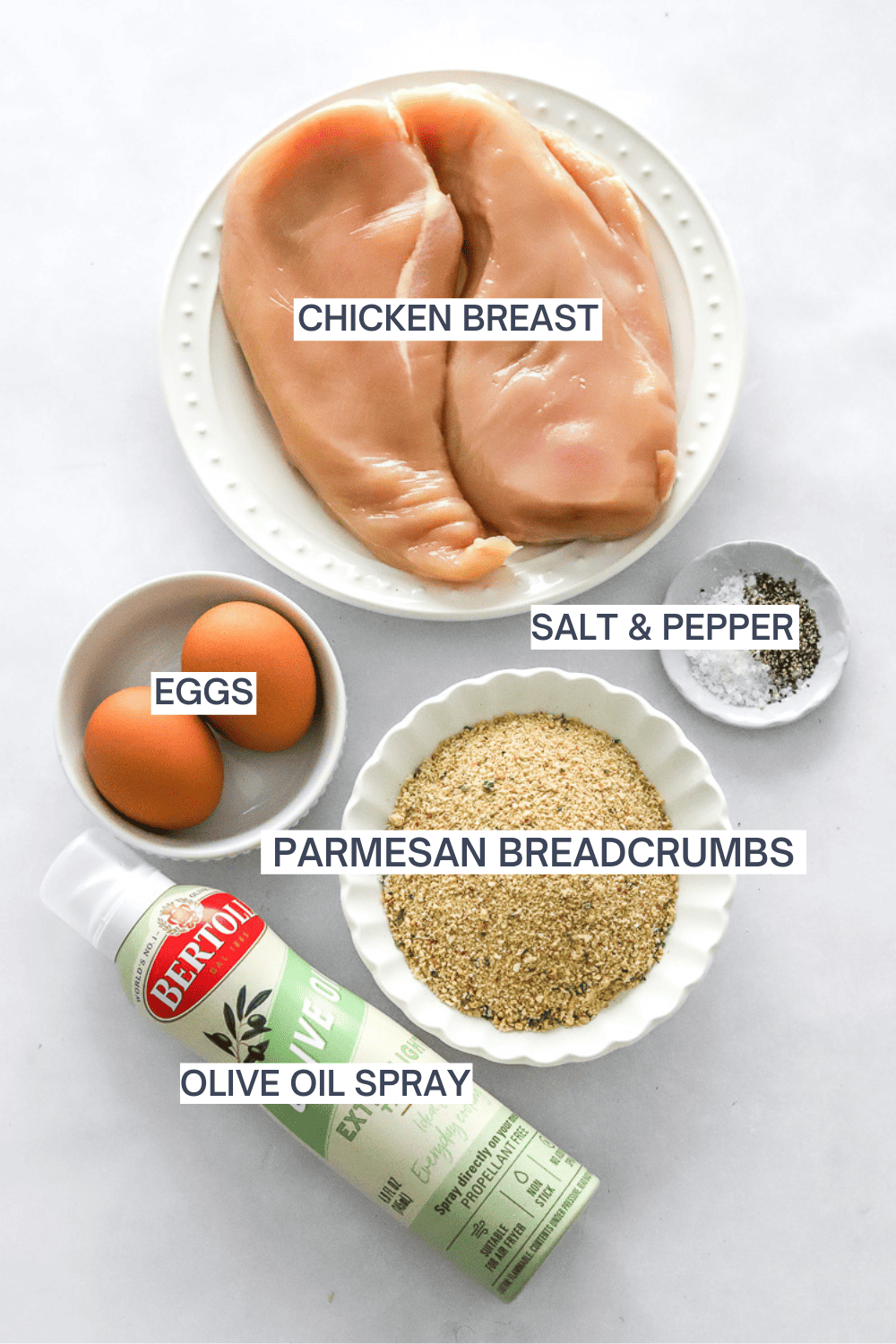 Ingredients for air fryer breaded chicken with labels over each ingredient. 