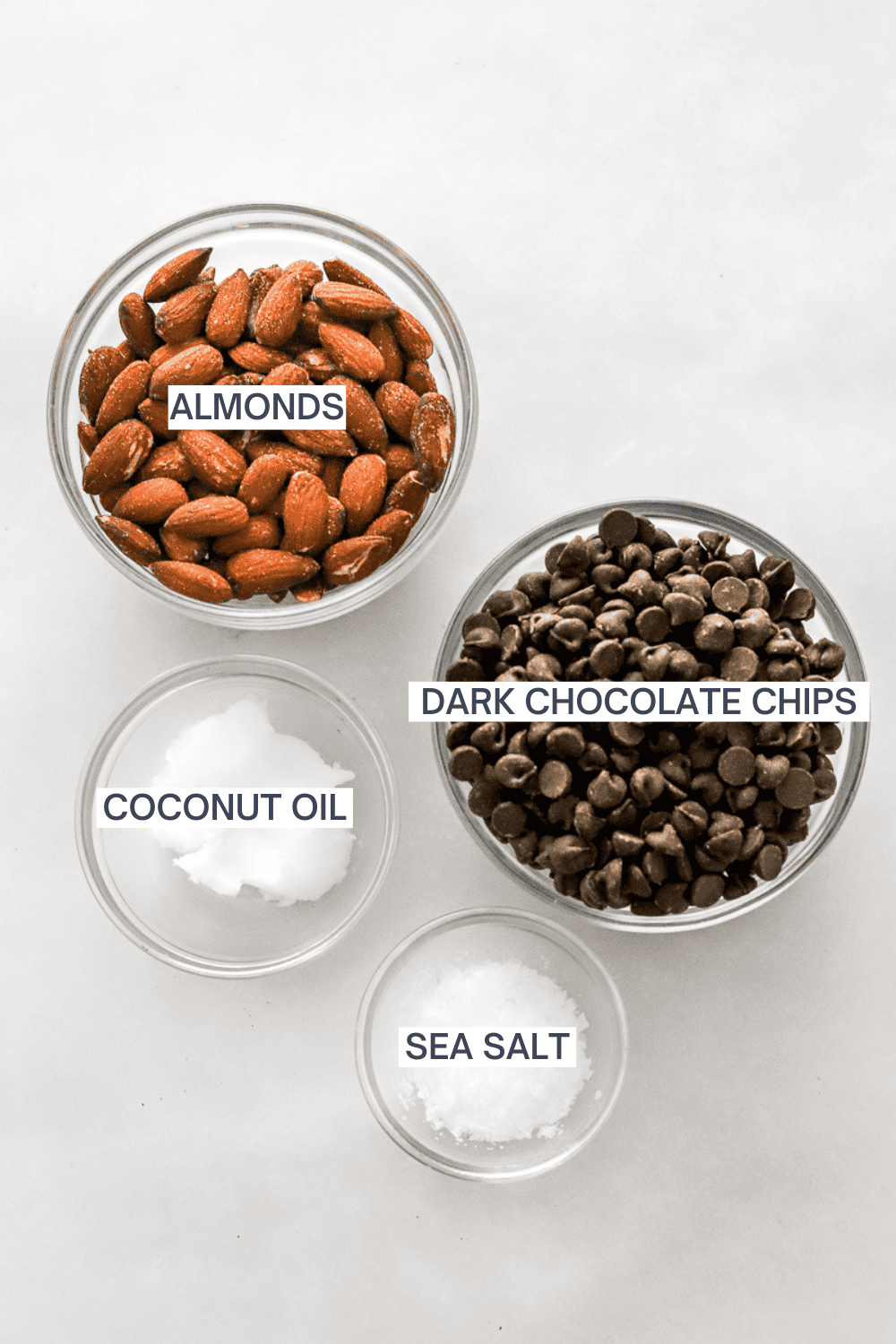 Ingredients for chocolate bark with almonds with labels over each ingredient.