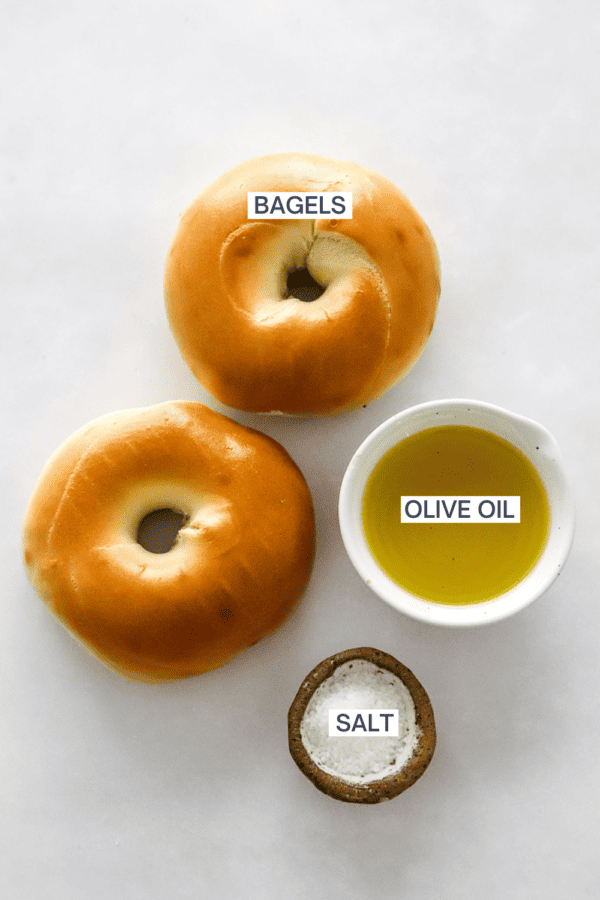Ingredients for homemade bagel chips with labels over each ingredient.