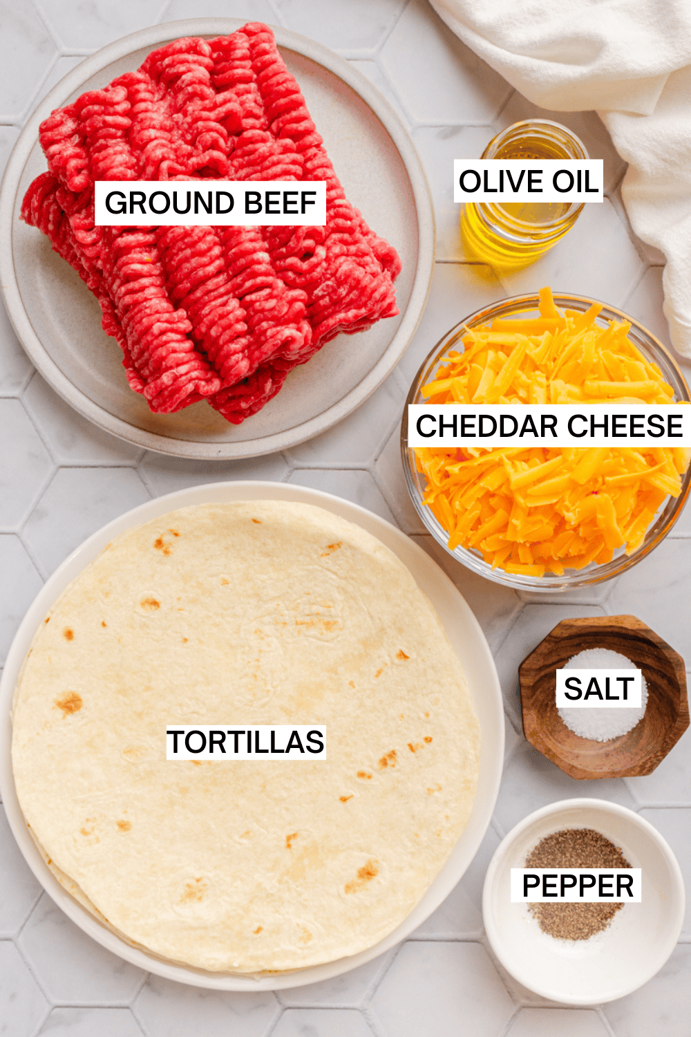 Ingredients for smash tacos with ground beef with labels over each ingredient. 