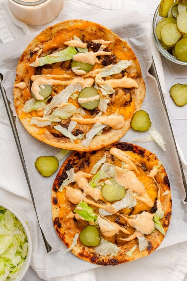 Pan with burger smash tacos on it.