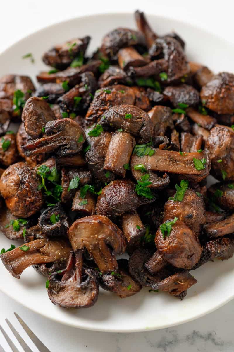 Air fryer cooked mushrooms toped with parsley.