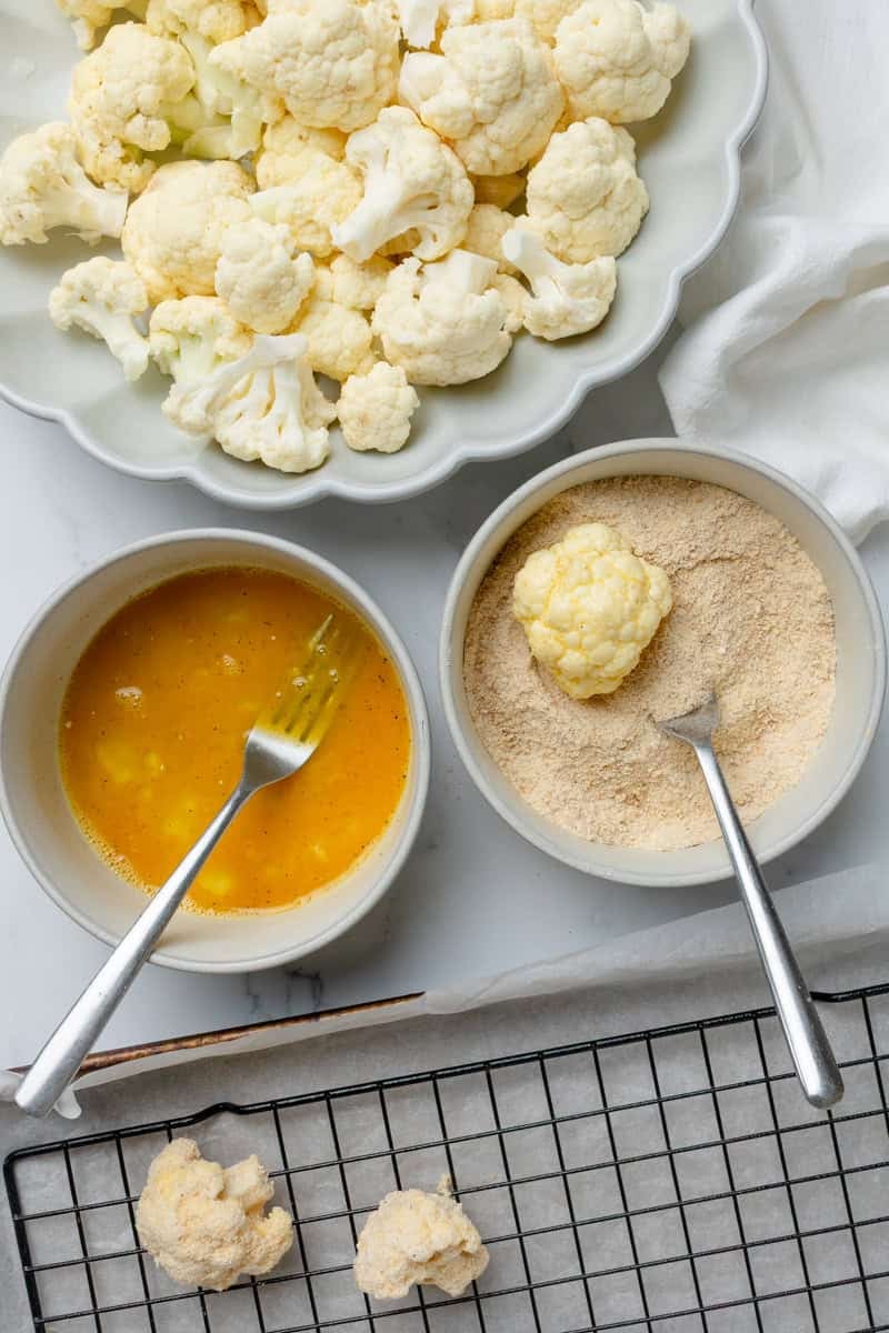 Dredging station setup for coating cauliflower florets.