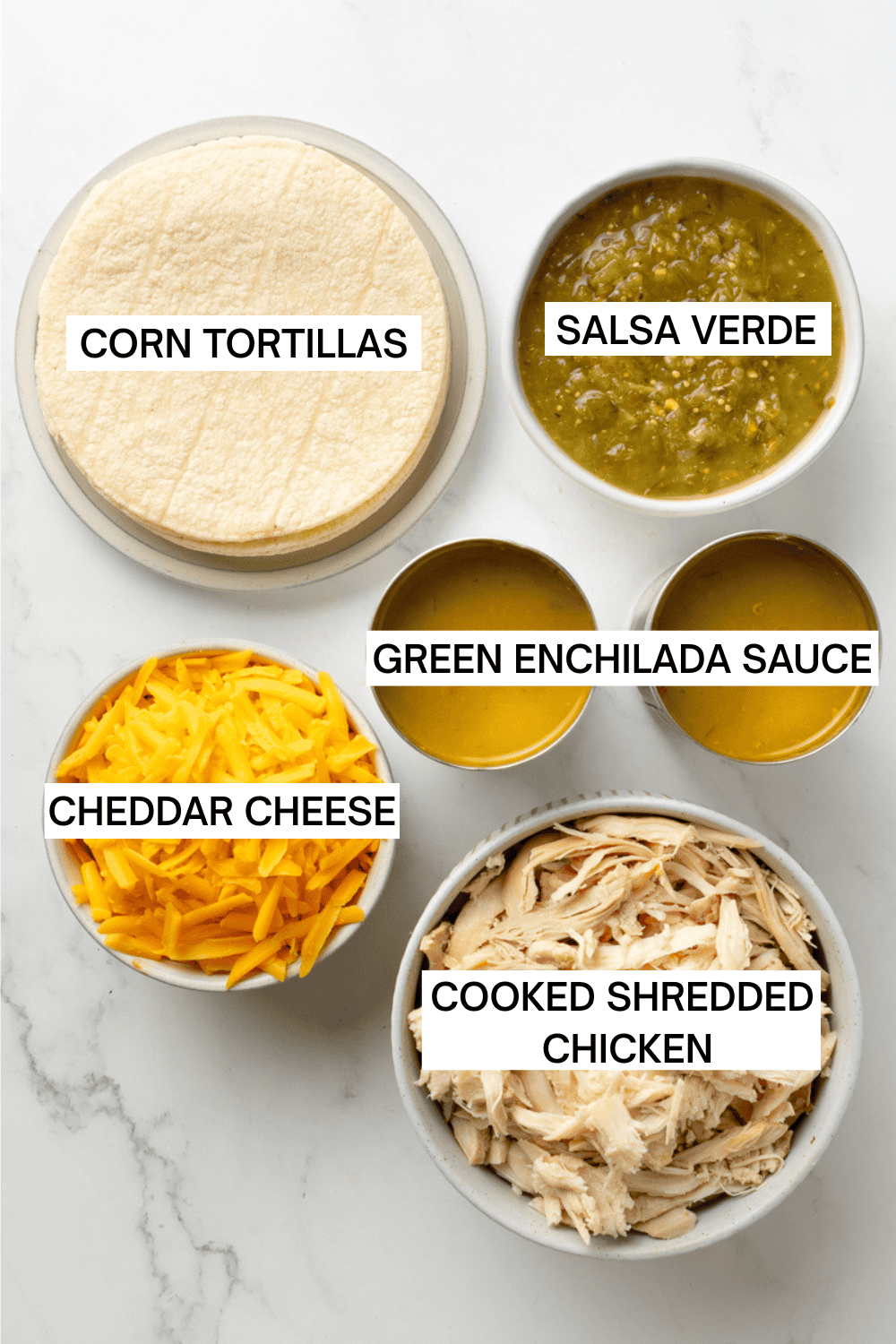 Ingredients for green chicken enchiladas in bowls with labels over each ingredient. 