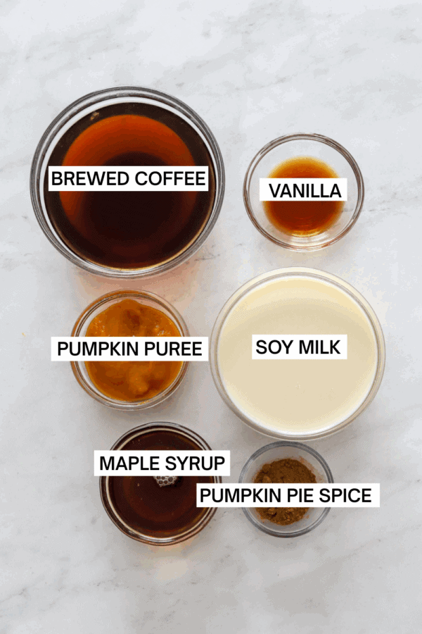 Ingredients for pumpkin spice latte's in bowls with labels over each ingredient.