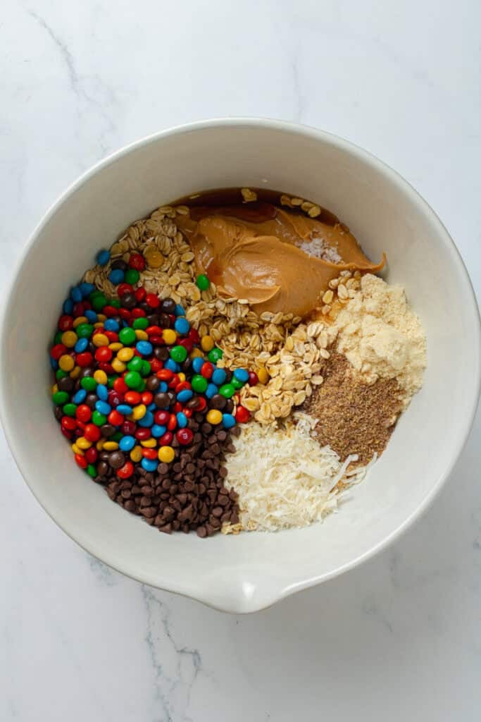 Ingredients for monster cookie bites in a mixing bowl. 