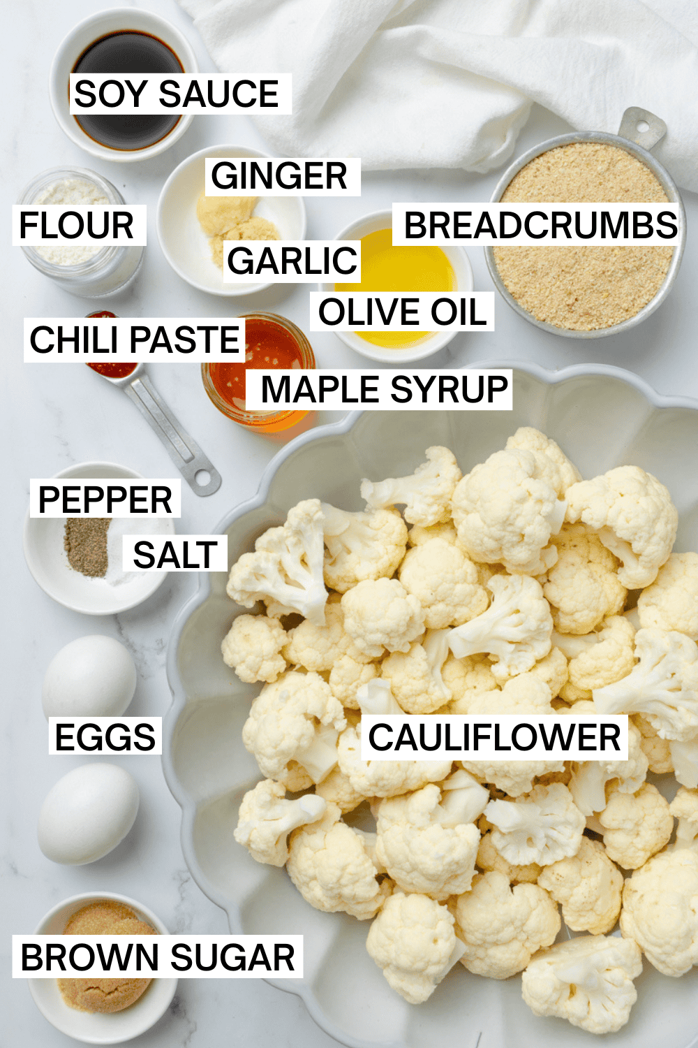 Ingredients for sweet and spicy cauliflower bites with labels over each ingredient.