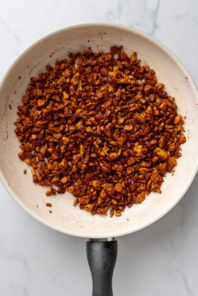 Sautéed crumbled tofu in pan.