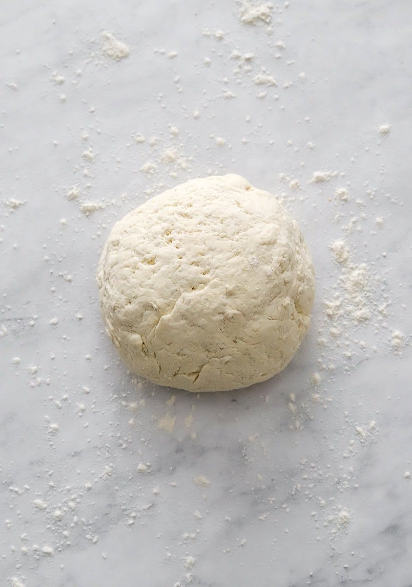 Ball of dough on a floured surface. 