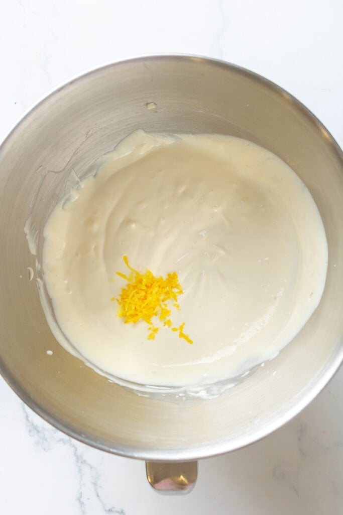 Lemon yogurt filling in a metal mixing bowl. 