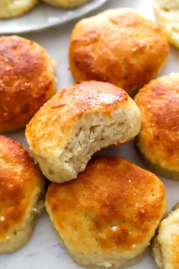 Cooked Greek yogurt biscuits with a bite taken out of one.