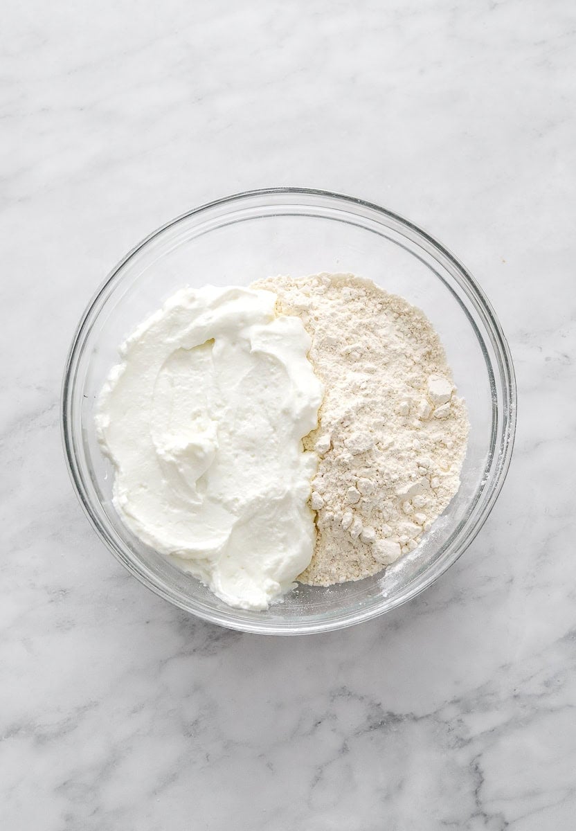 Flour and yogurt in a glass bowl.