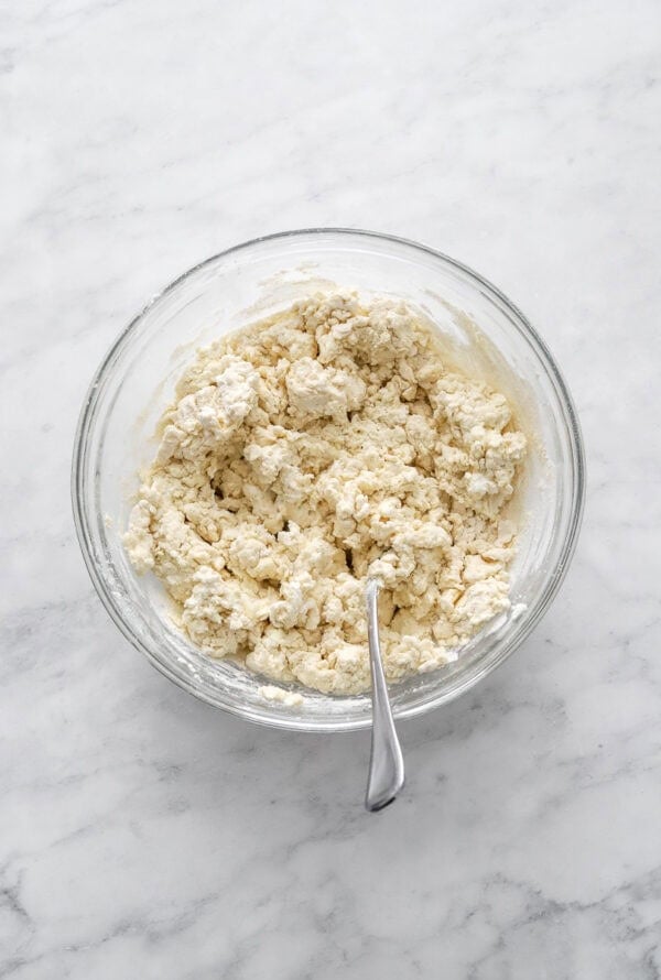 Greek yogurt biscuit dough in a bowl with a fork in the bowl.