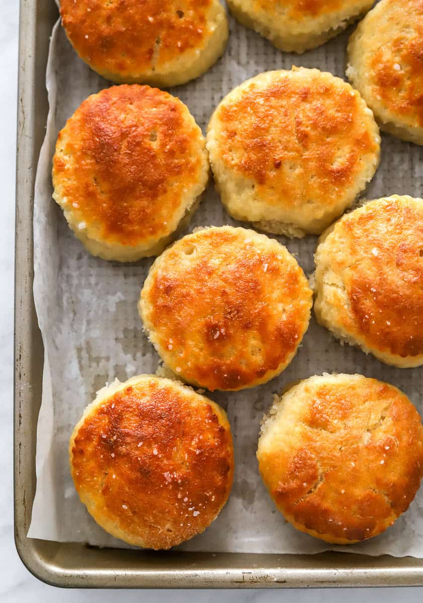 Greek yogurt biscuits on a lined pan.