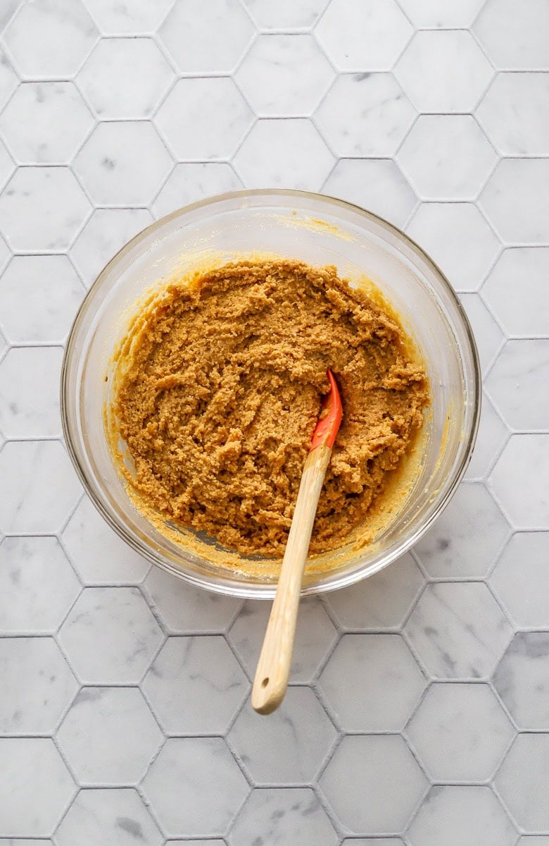Peanut butte filling in glass bowl with small mixing spoon in the bowl.