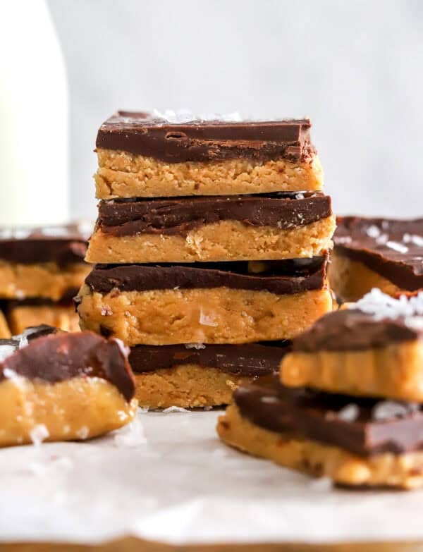Stack of homemade peanut butter bars with more around it.