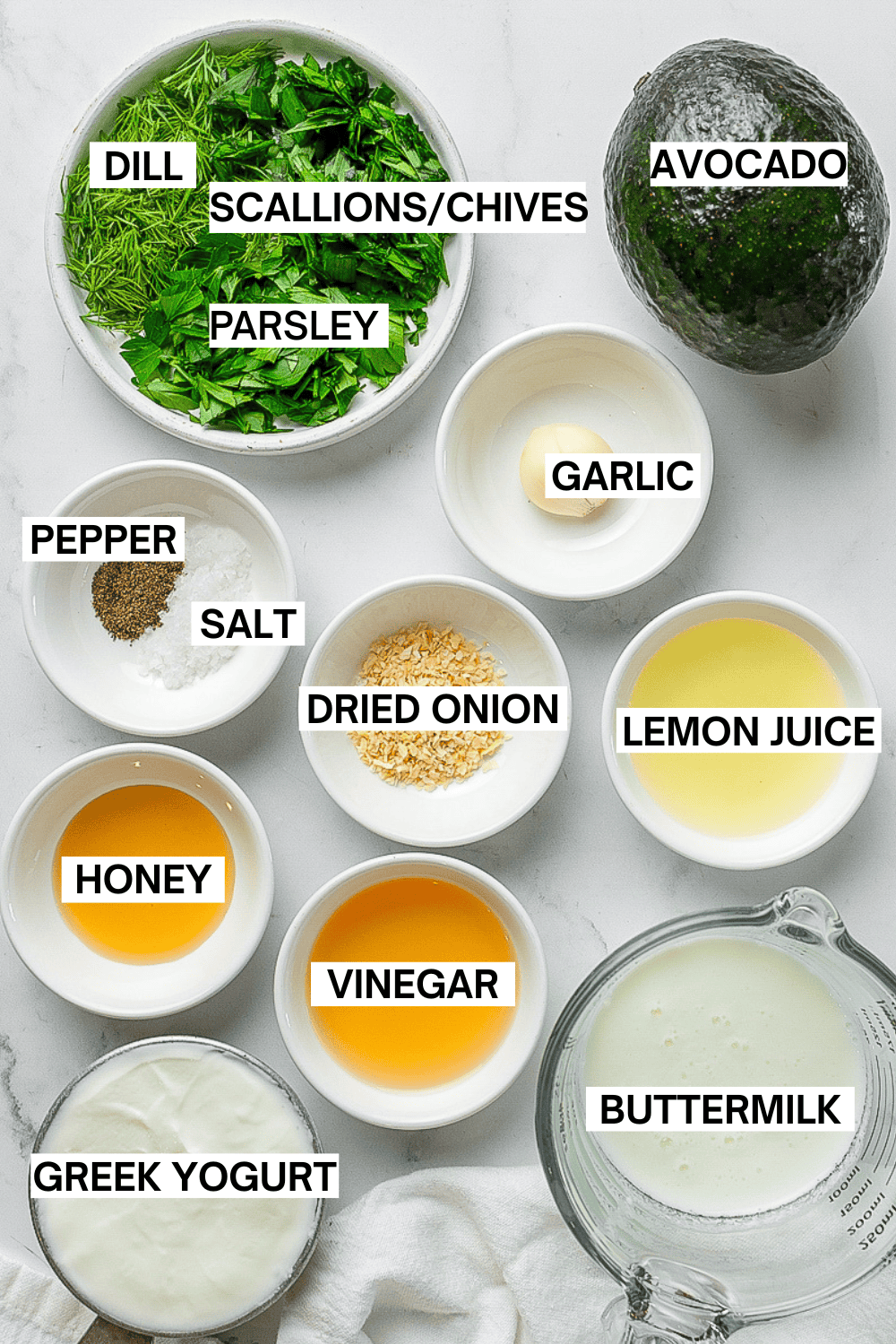 Ingredients for avocado ranch dressing in bowls with labels over each ingredient.