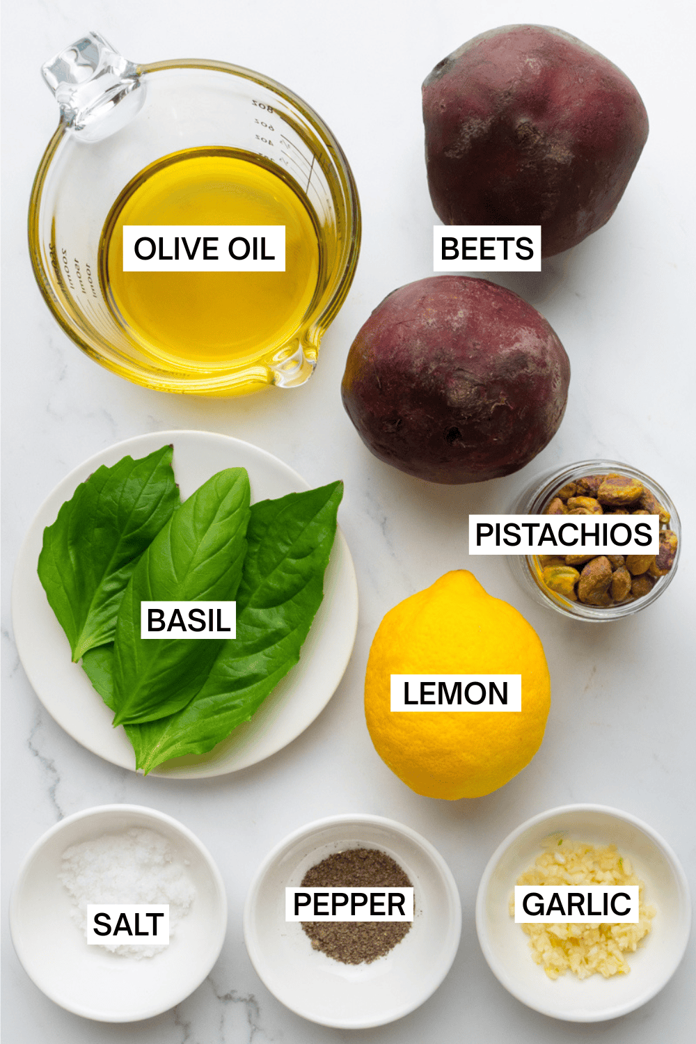 Ingredients for beet pesto in bowls with labels over each ingredient.