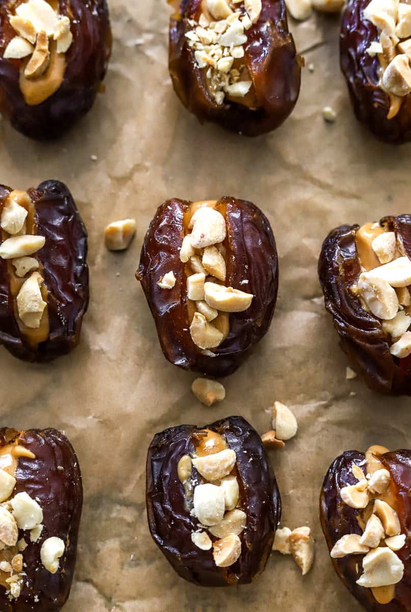 Parchment lined pan filled with peanut butter and nut filled dates.
