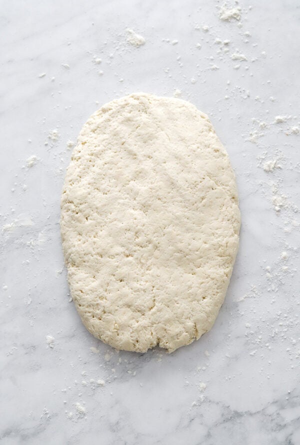 Rolled out biscuit dough rolled out on a flat surface.