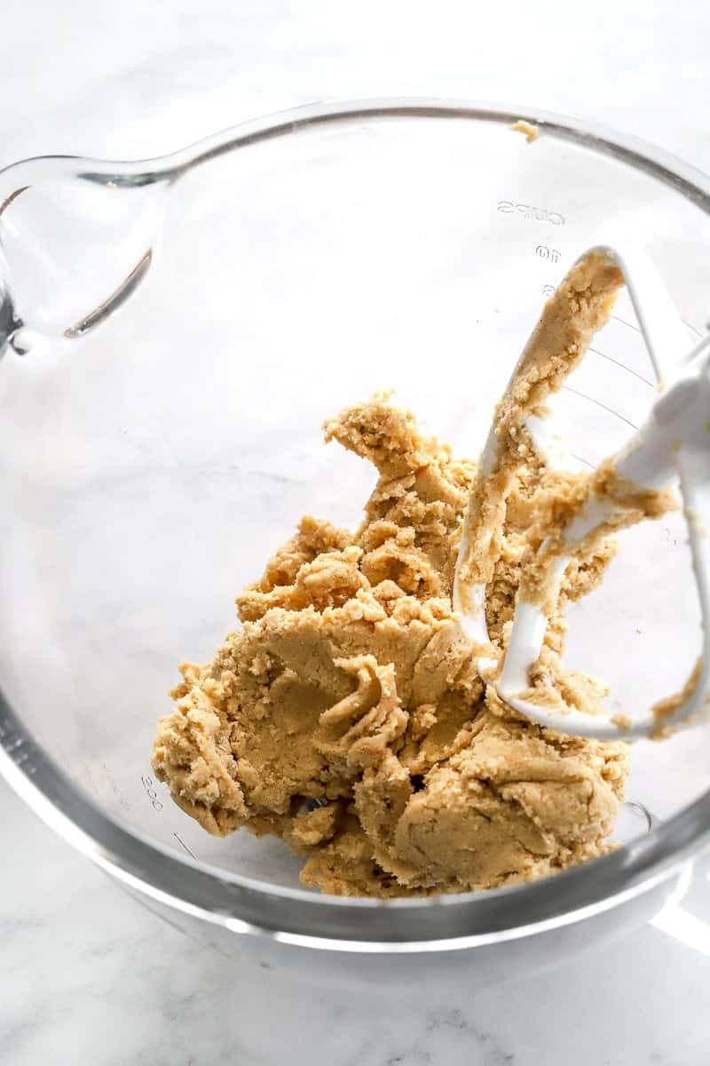 Cookie dough in a glass mixing bowl.