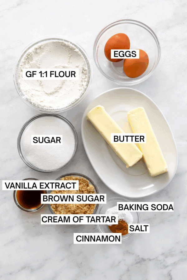 Ingredients for snickerdoodle cookies in bowls with labels over each ingredient.