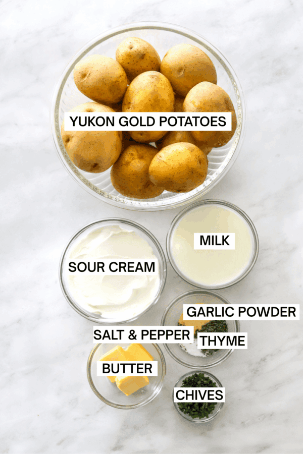 Ingredients for healthy mashed potatoes in bowls with labels over each ingredient.
