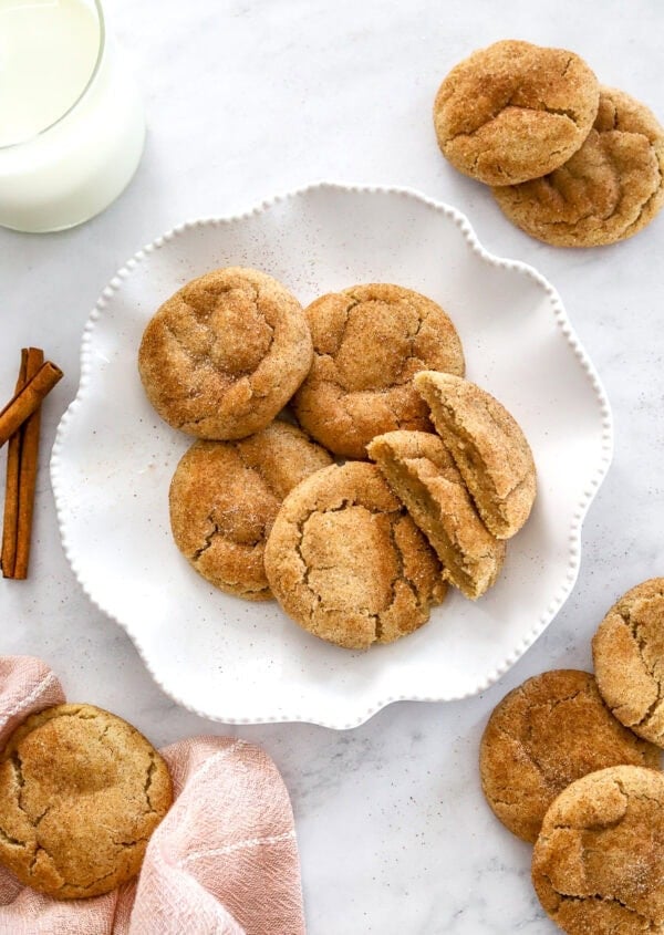 Plate of cinnamon cookies with more around it.