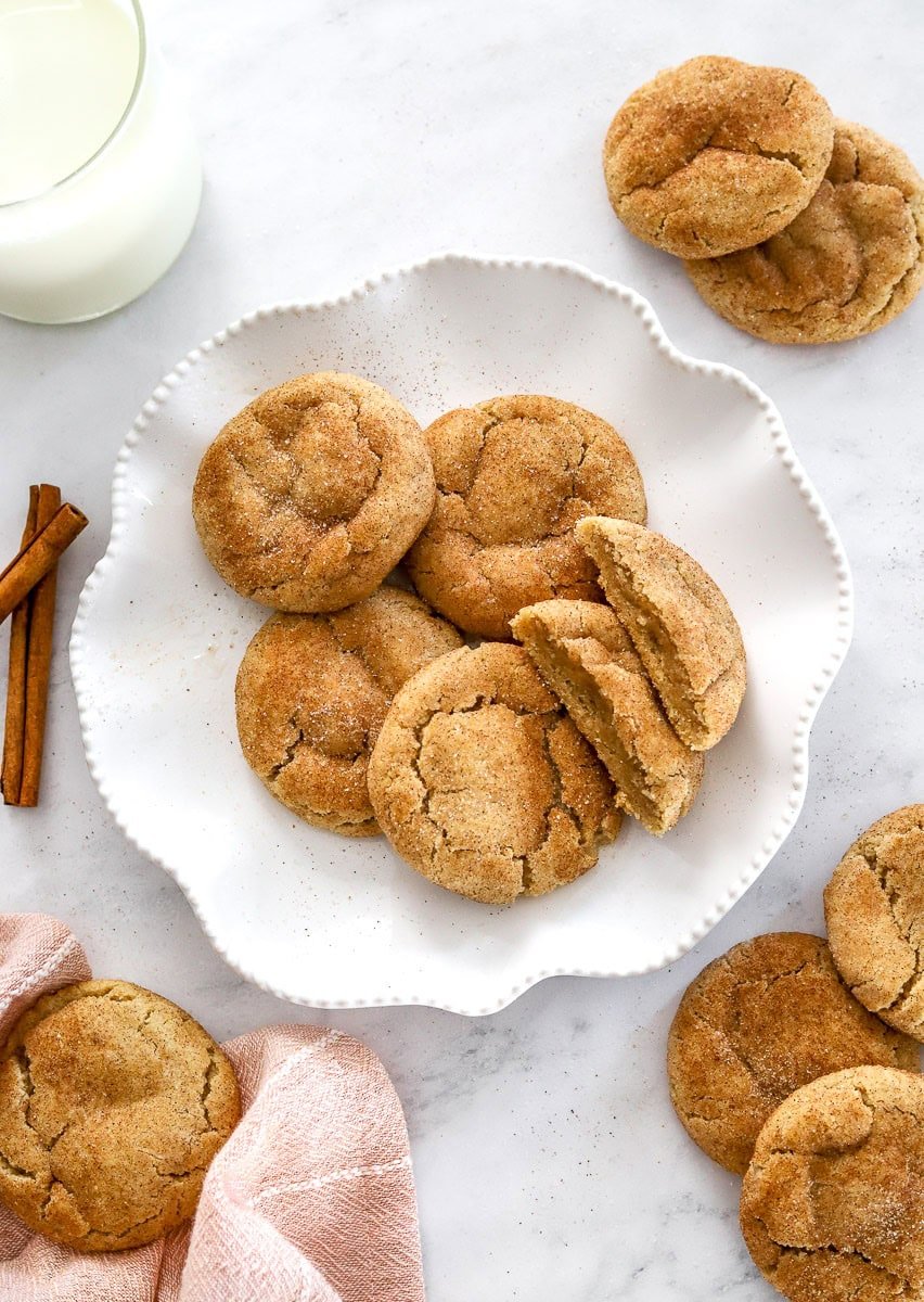 Plate of cinnamon cookies with more around it.