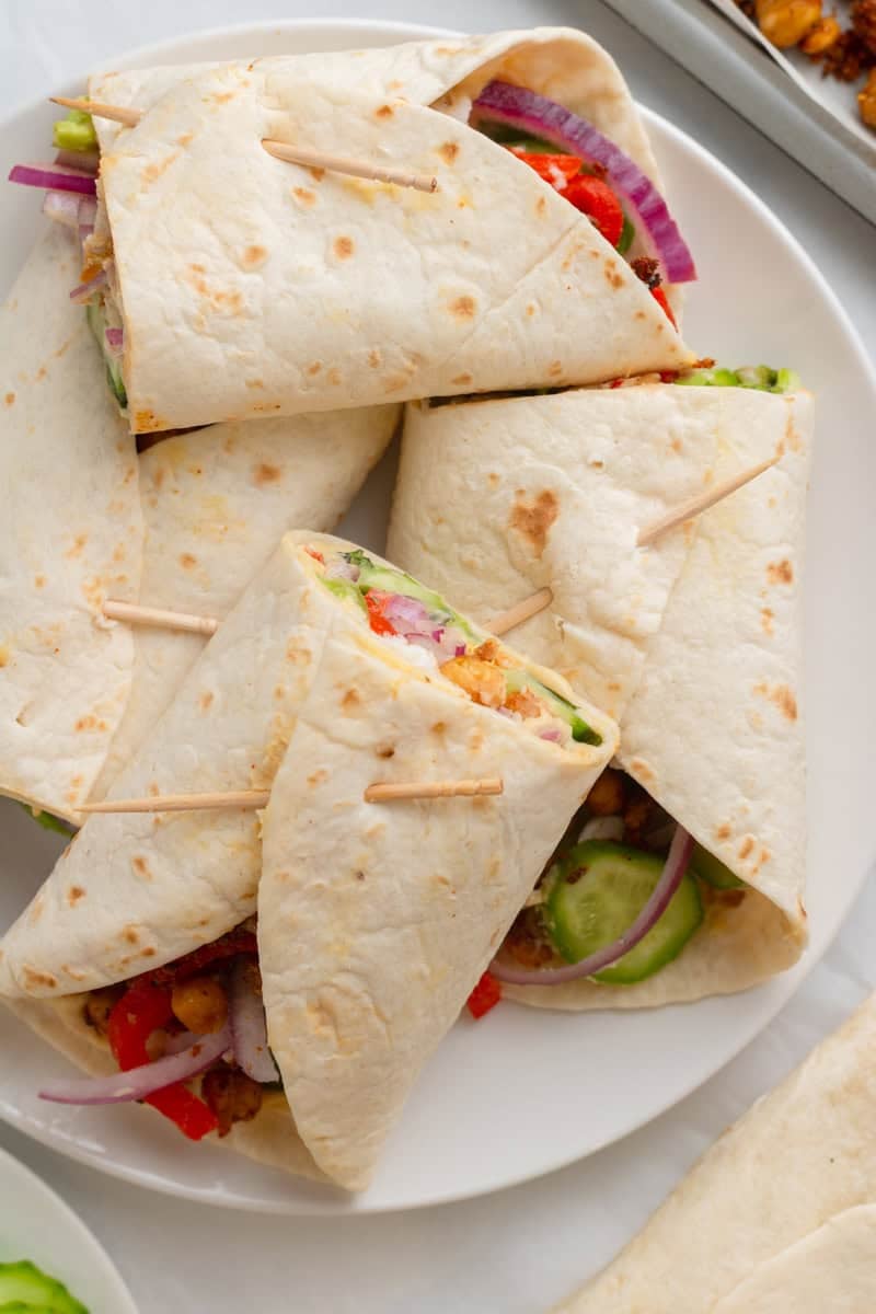 Plate full od humus chickpea wrap secured with toothpicks. 