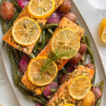 Platter full of sheet pan salmon and veggies.