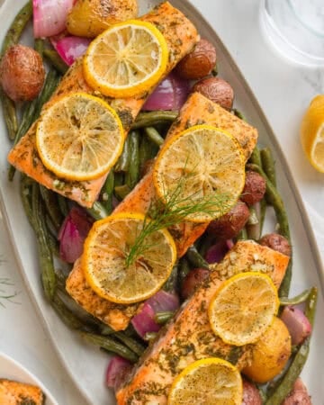 Platter full of sheet pan salmon and veggies.