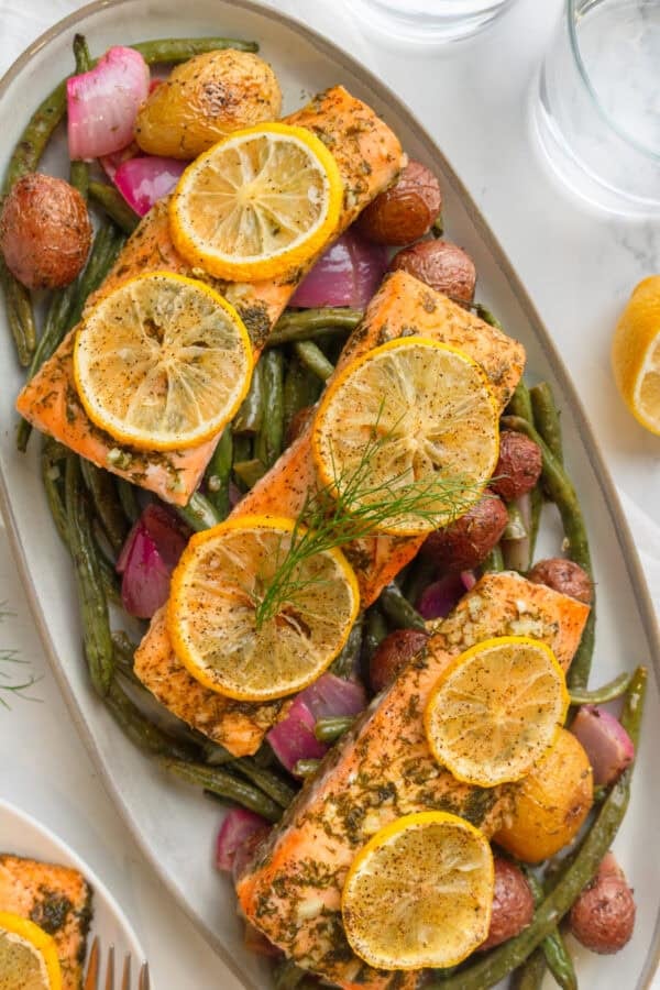 Platter full of sheet pan salmon and veggies.