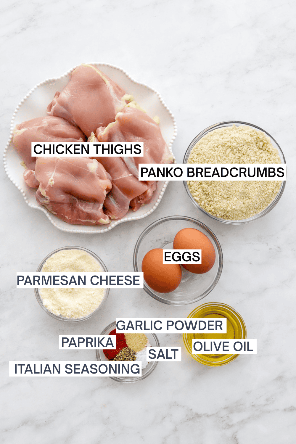 Ingredients for air fryer breaded chicken thighs with labels over each ingredient.