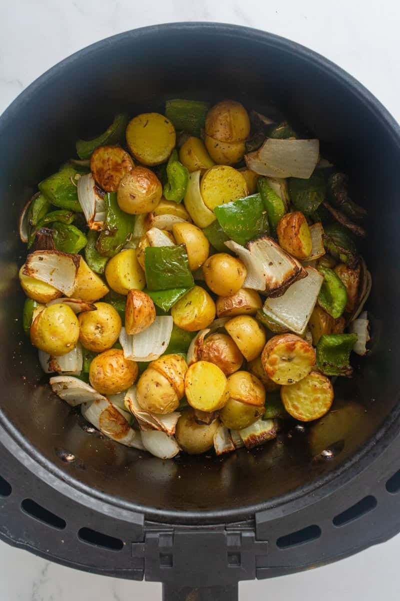 Cooked potatoes, peppers and onion in an air fryer. 