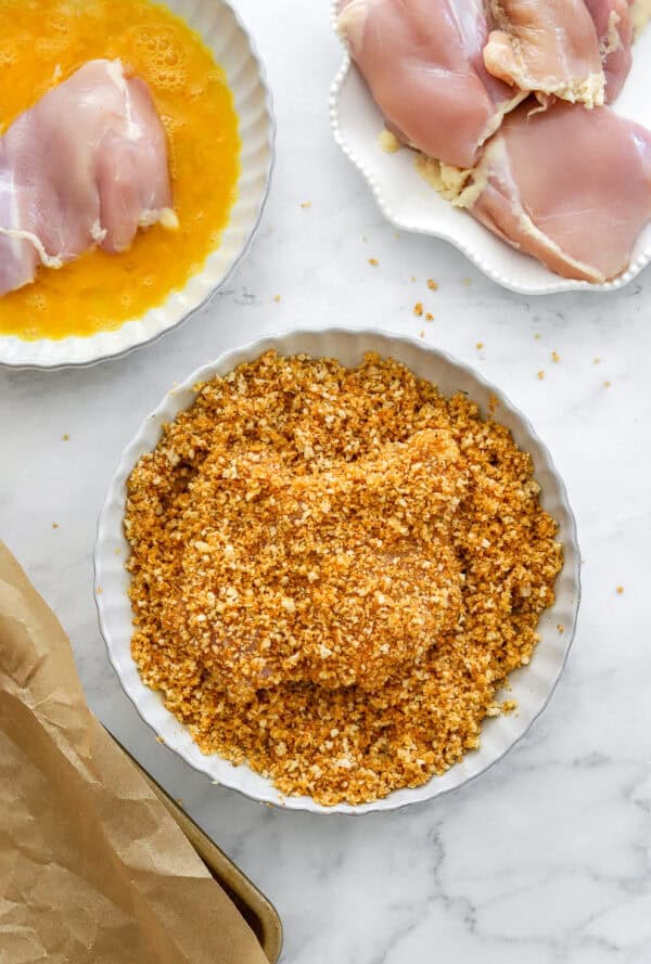 Dredging setup for coating boneless chicken thighs.