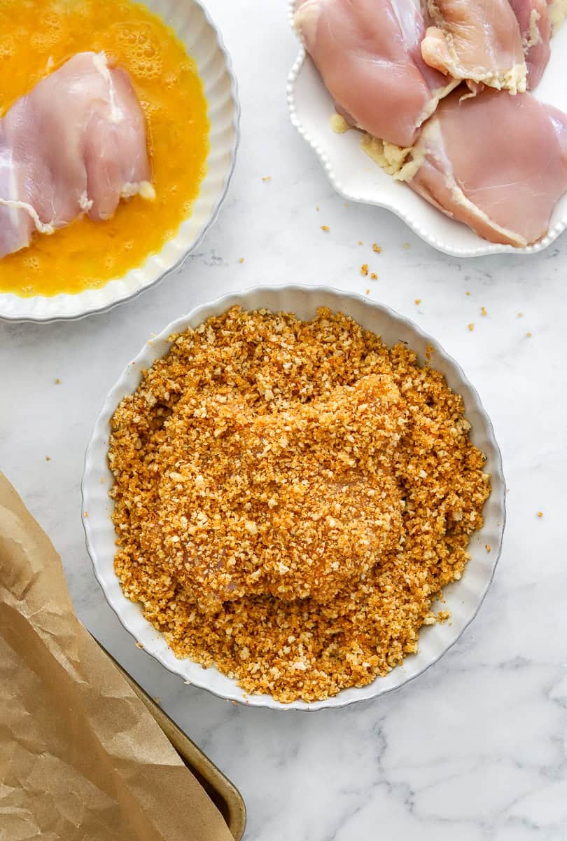 Dredging setup for coating boneless chicken thighs.