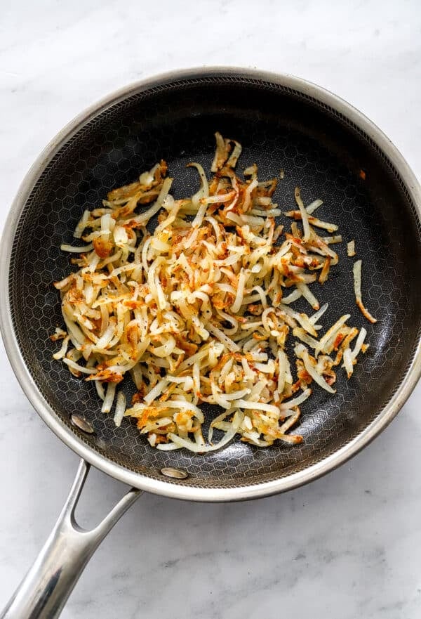 Cooke shredded potato in a saute pan.