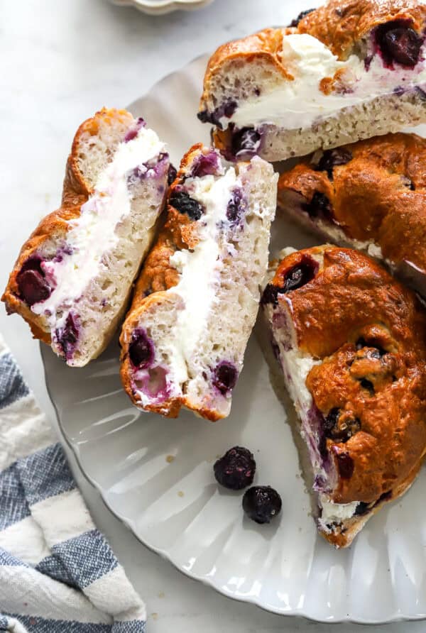 Blueberry bagel cream cheese sandwiches in a plate.