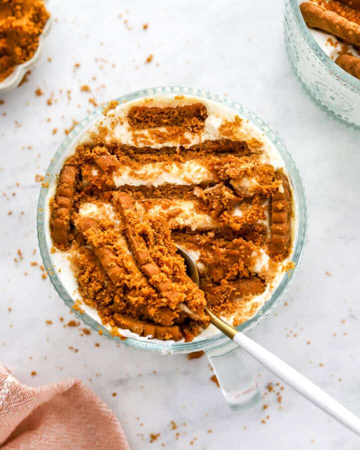 Dish of viral yogurt cheesecake with a spoonful on top and a pink towel in front of it.