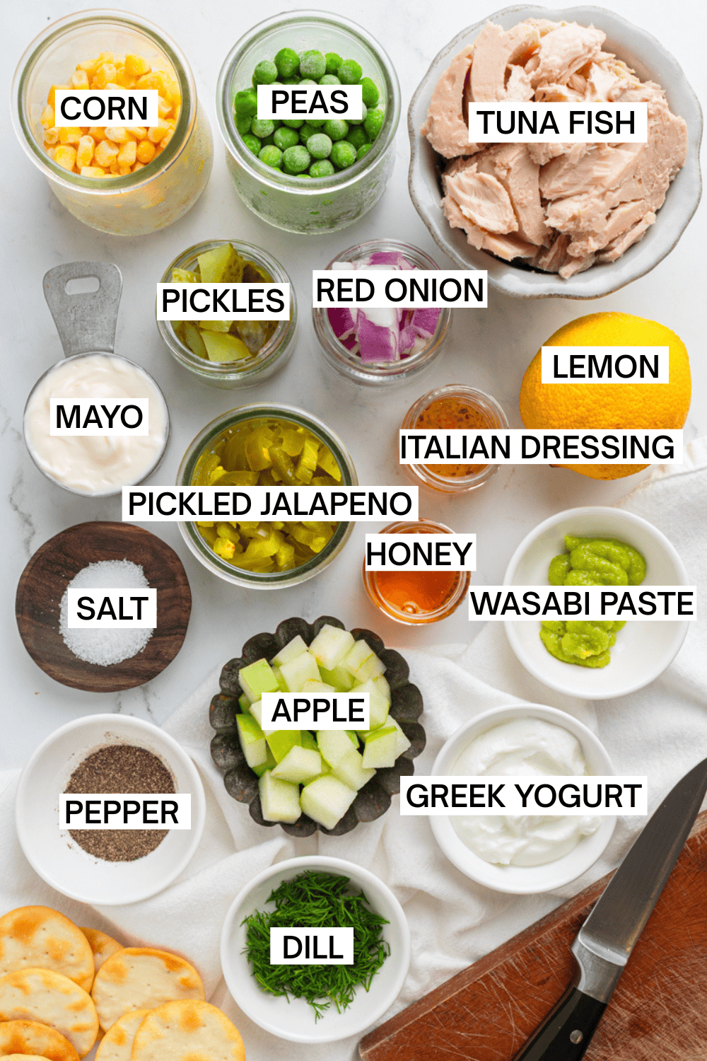 Ingredients for Matthew Mcconaughey's tuna salad in bowls with labels over each ingredient. 