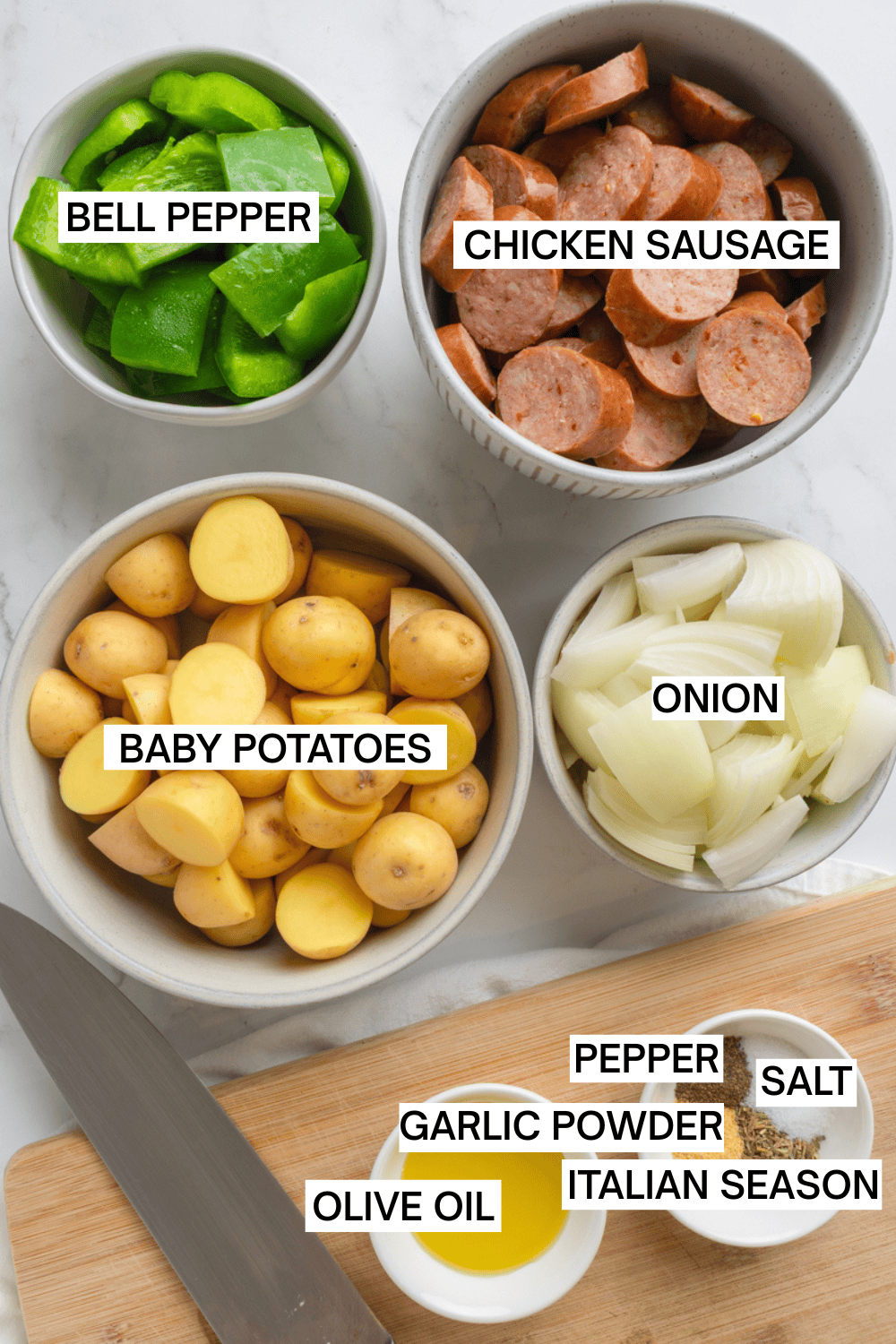 Ingredients for air fryer sausage and potatoes in bowls with labels over each ingredient. 
