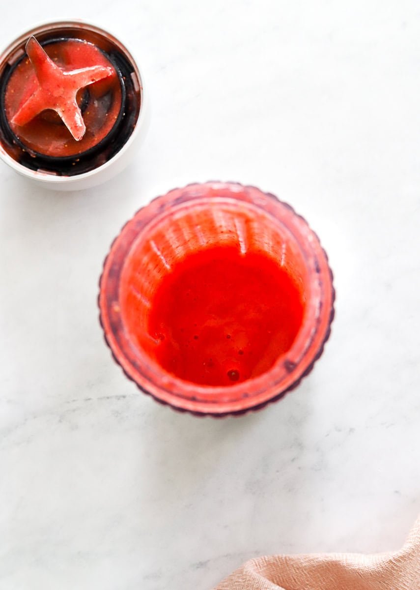 Blended strawberries in blender bottle.