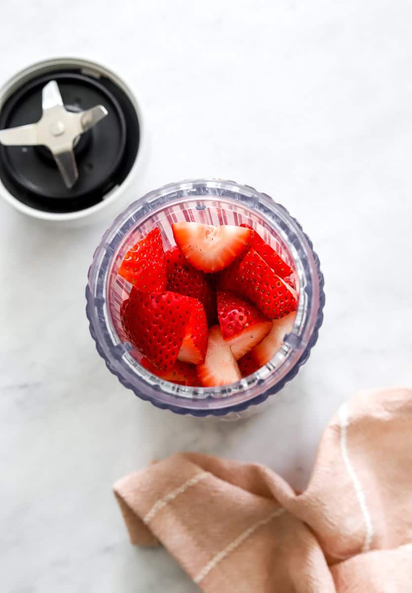 Chopped berries in blender bottle.