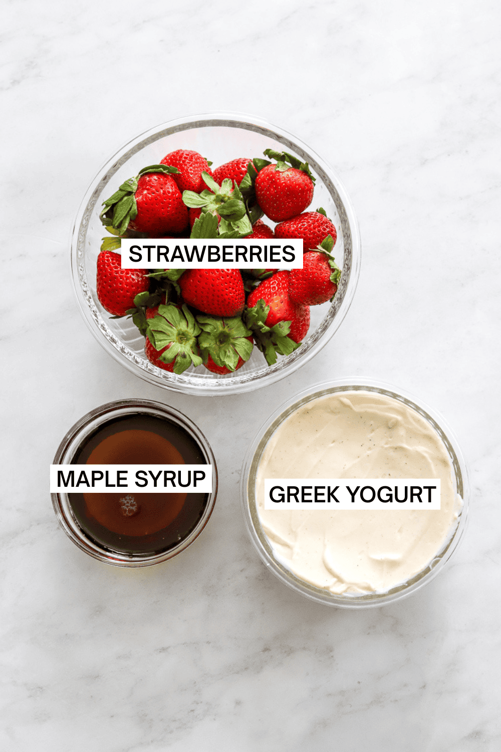 Ingredietns for ninja creami strawberry ice cream in bowls with labels over each ingredient. 